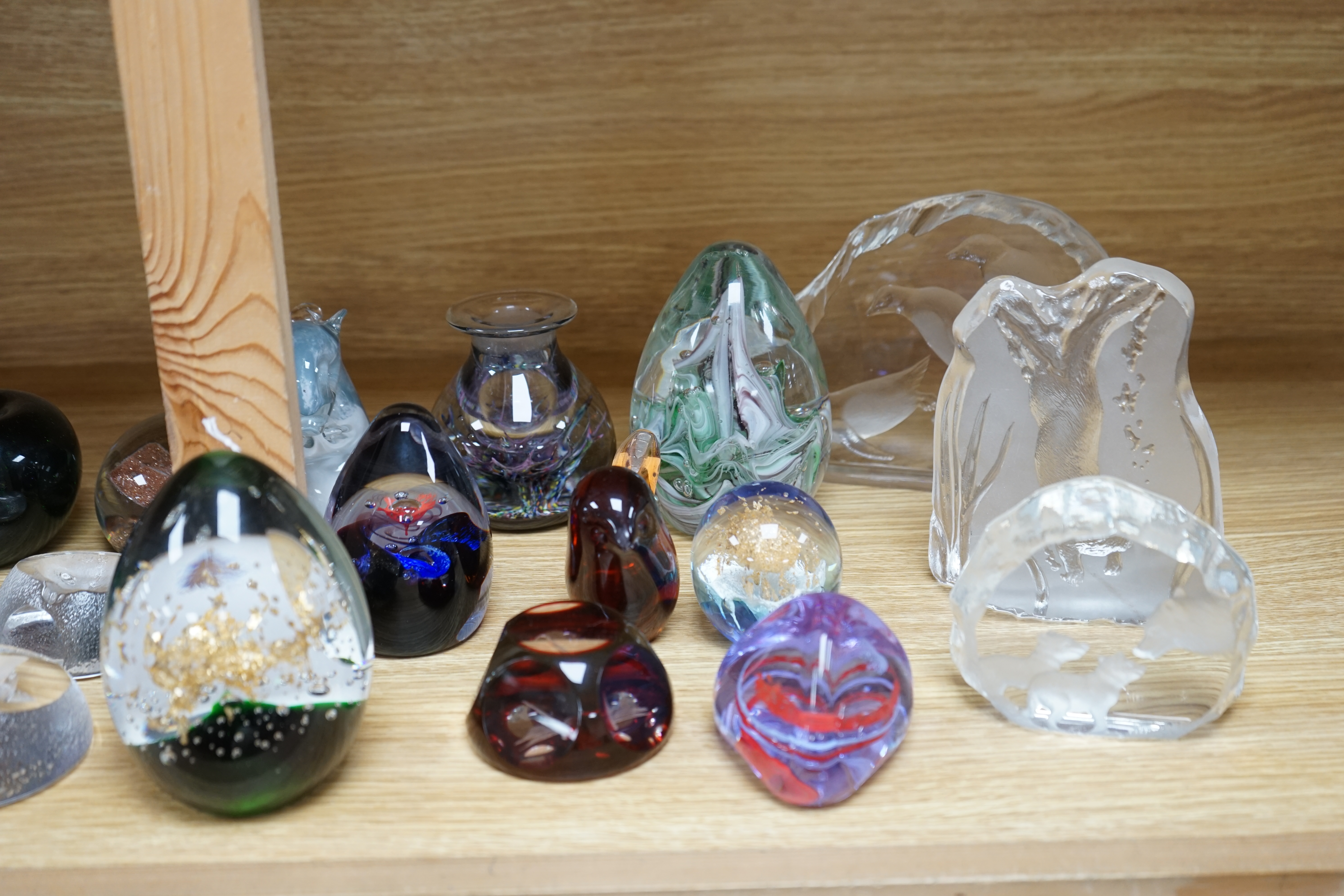 Twenty three glass paperweights, including five with silhouettes of animals, and others of unusual shape. Condition - good